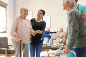 standing elderly lady being supported by carer