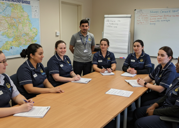a group of carers having a discussion sat around a table